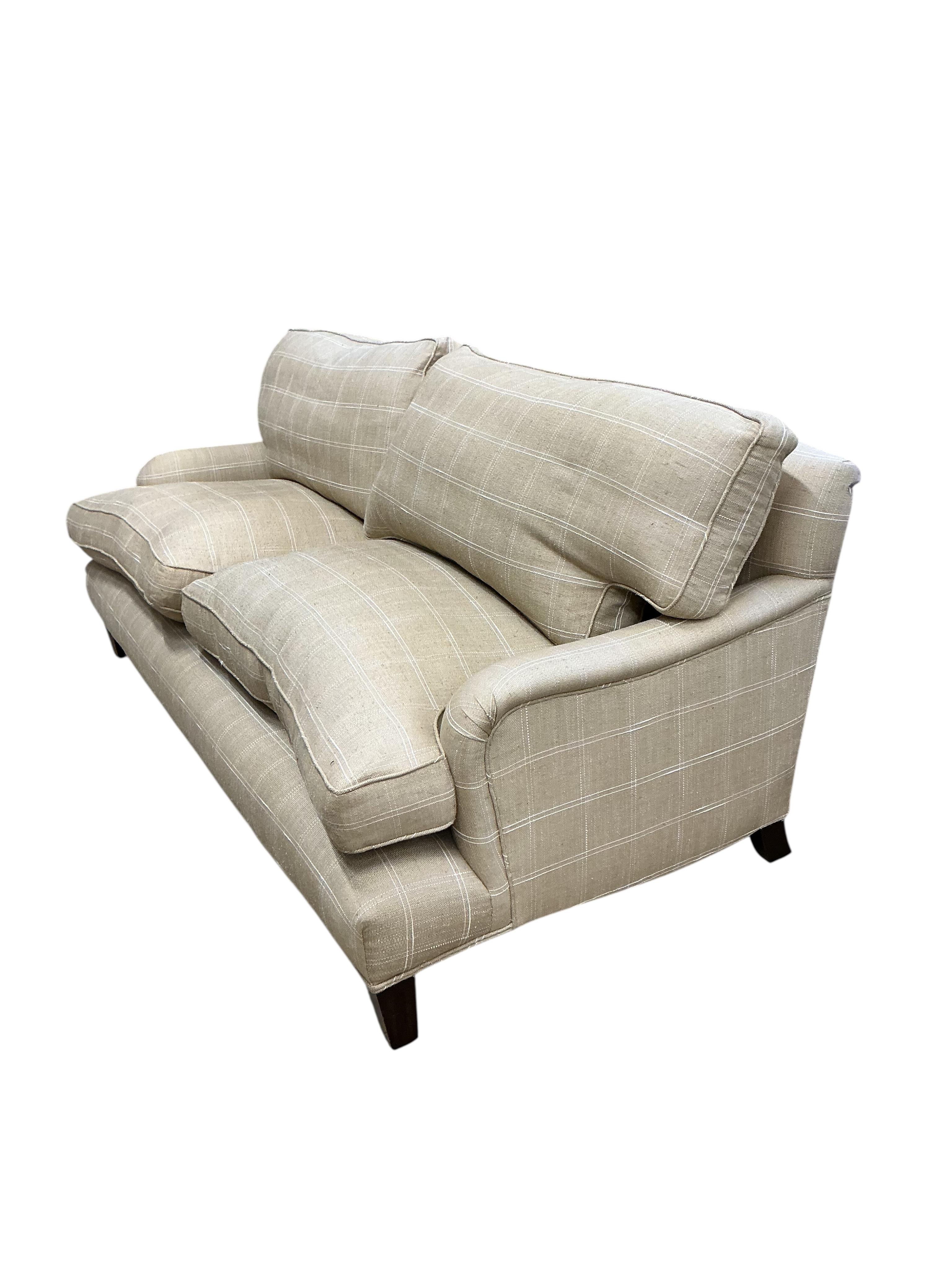 A pair of large grey and white squared upholstered settees, width 200cm, depth 90cm, height 84cm and a pair of matching armchairs